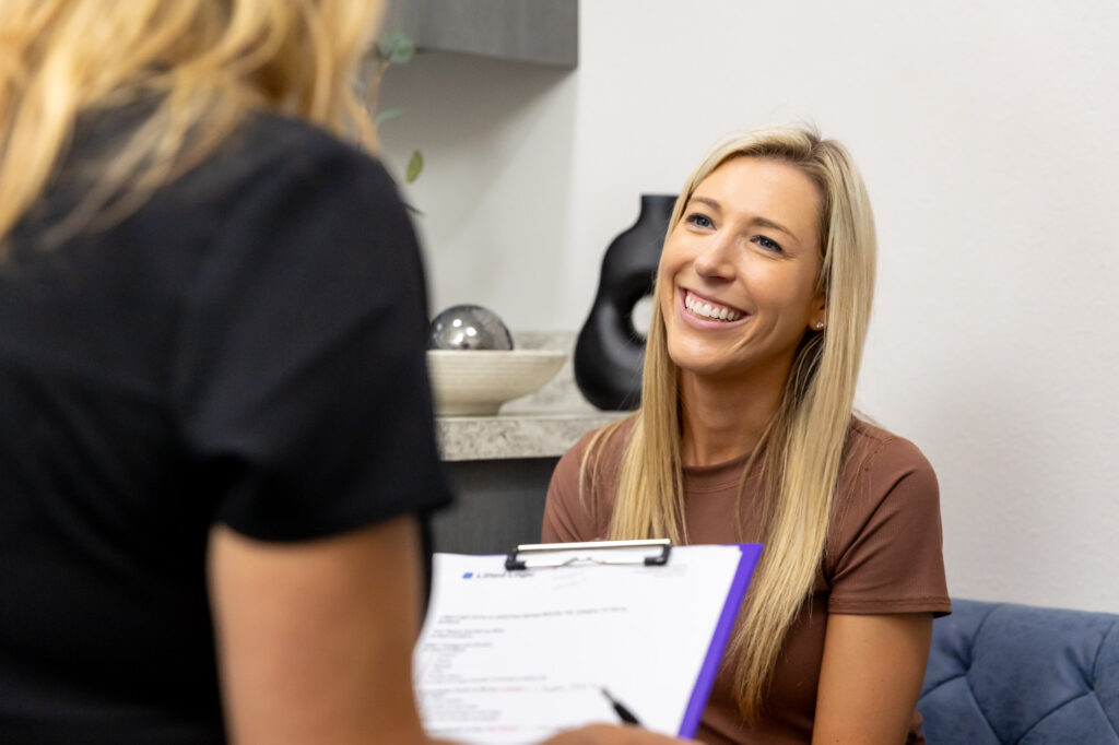 A patient gets recommendations for her unique skin care in Arlington.